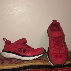 Red and black Under Armour boys shoes